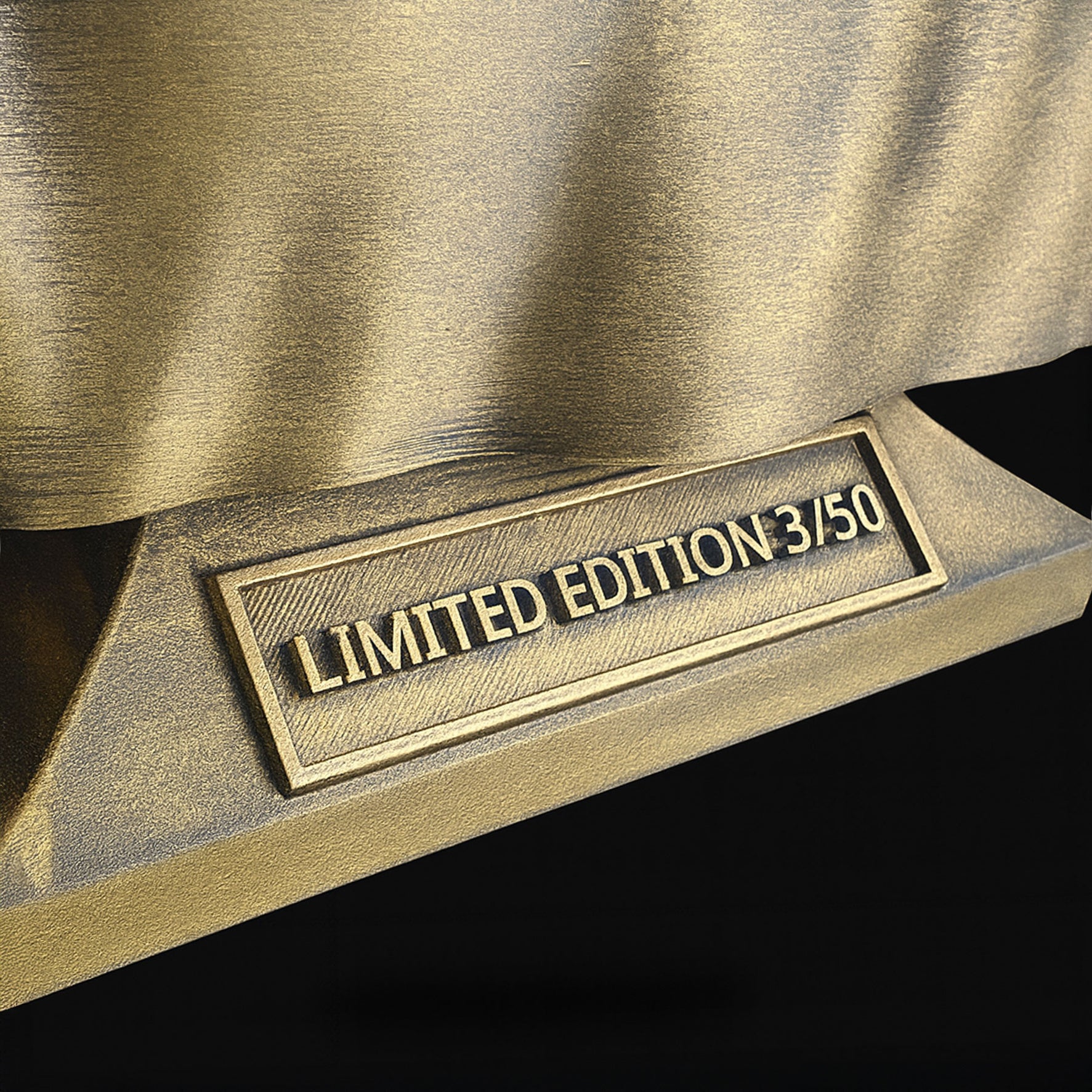 Charlie Kirk bust gold nameplate close-up — engraved plaque reflective finish