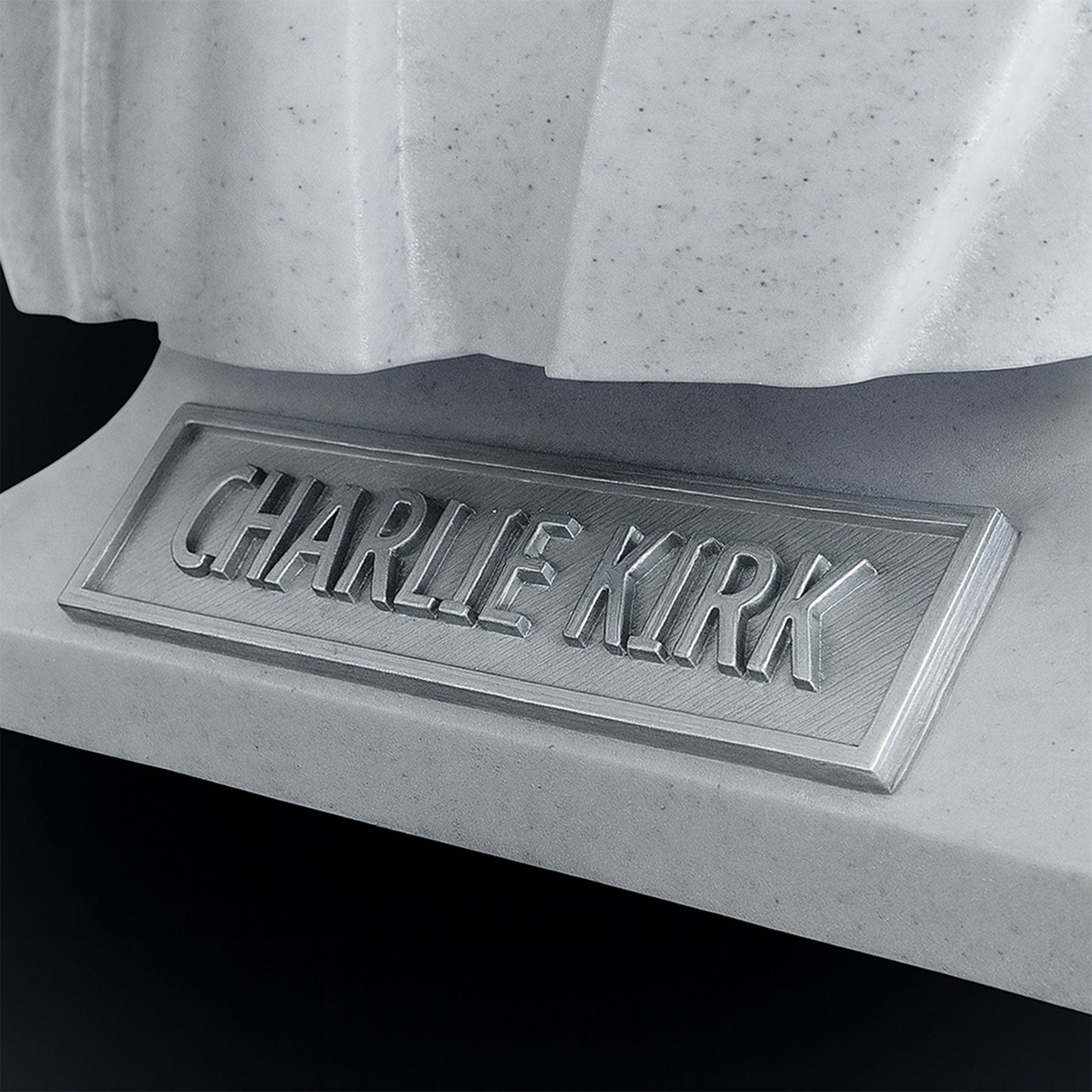 Charlie Kirk bust engraved nameplate close-up — minimalist marble look